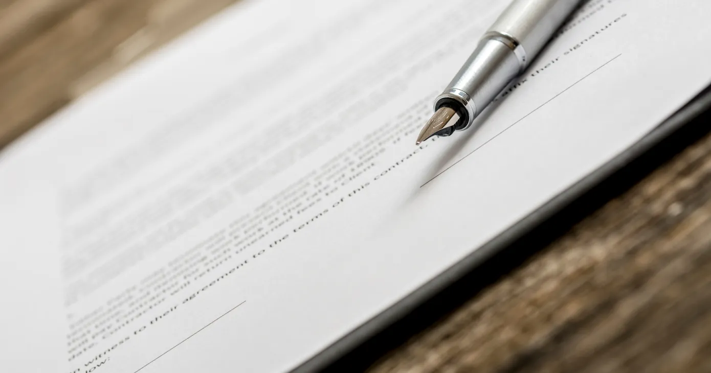 Closeup of ink pen lying on a contract