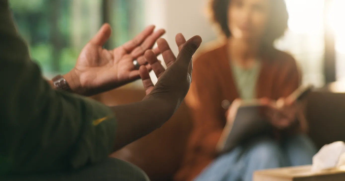 Hands, psychologist and consultation for mental health, therapy or notebook for support in office. Client, counseling and person with depression, psychiatry and notes to help with anxiety 