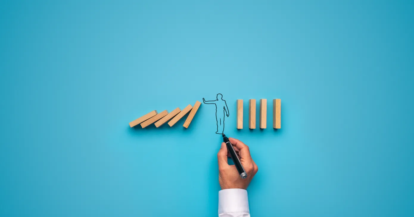 Handdrawn businessman stopping falling dominos