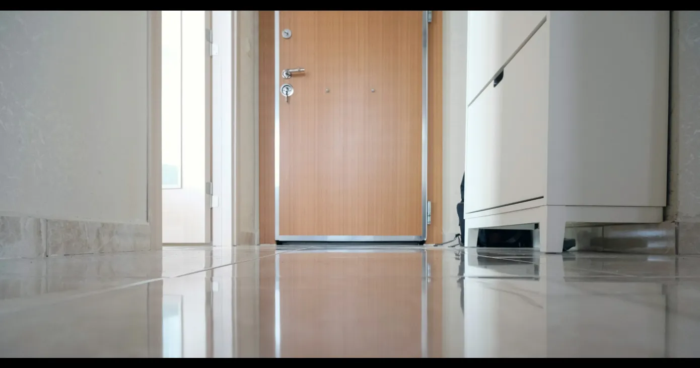 Porte en bois fermée au bout d'un couloir clair